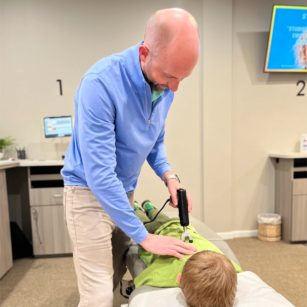 Chiropractor Lake in the Hills IL John Eickert Adjusting Boy